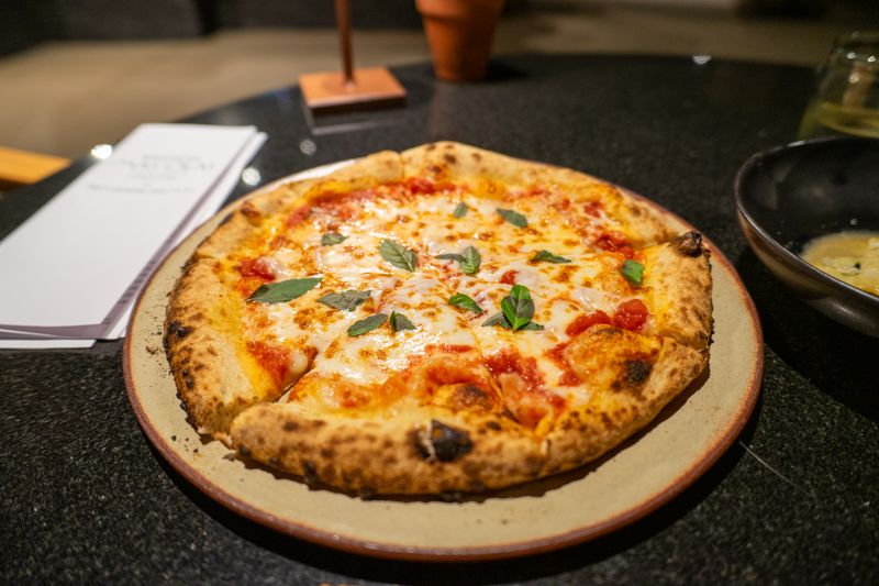 Classic Margherita pizza with fresh basil and mozzarella